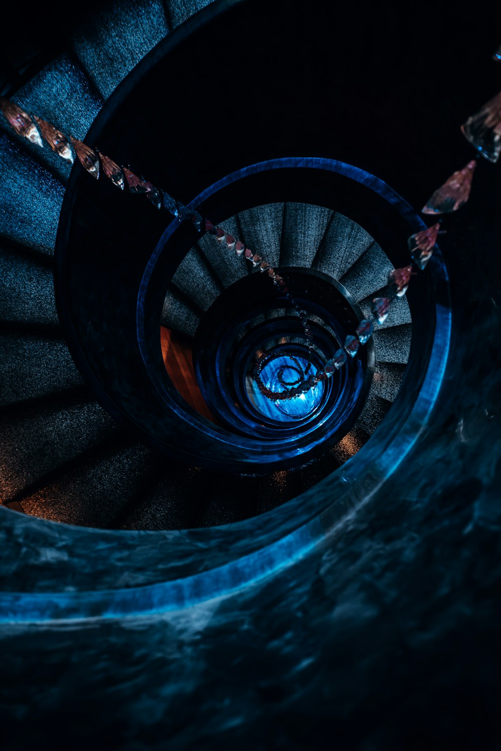 a spiral staircase in a building lit up at night