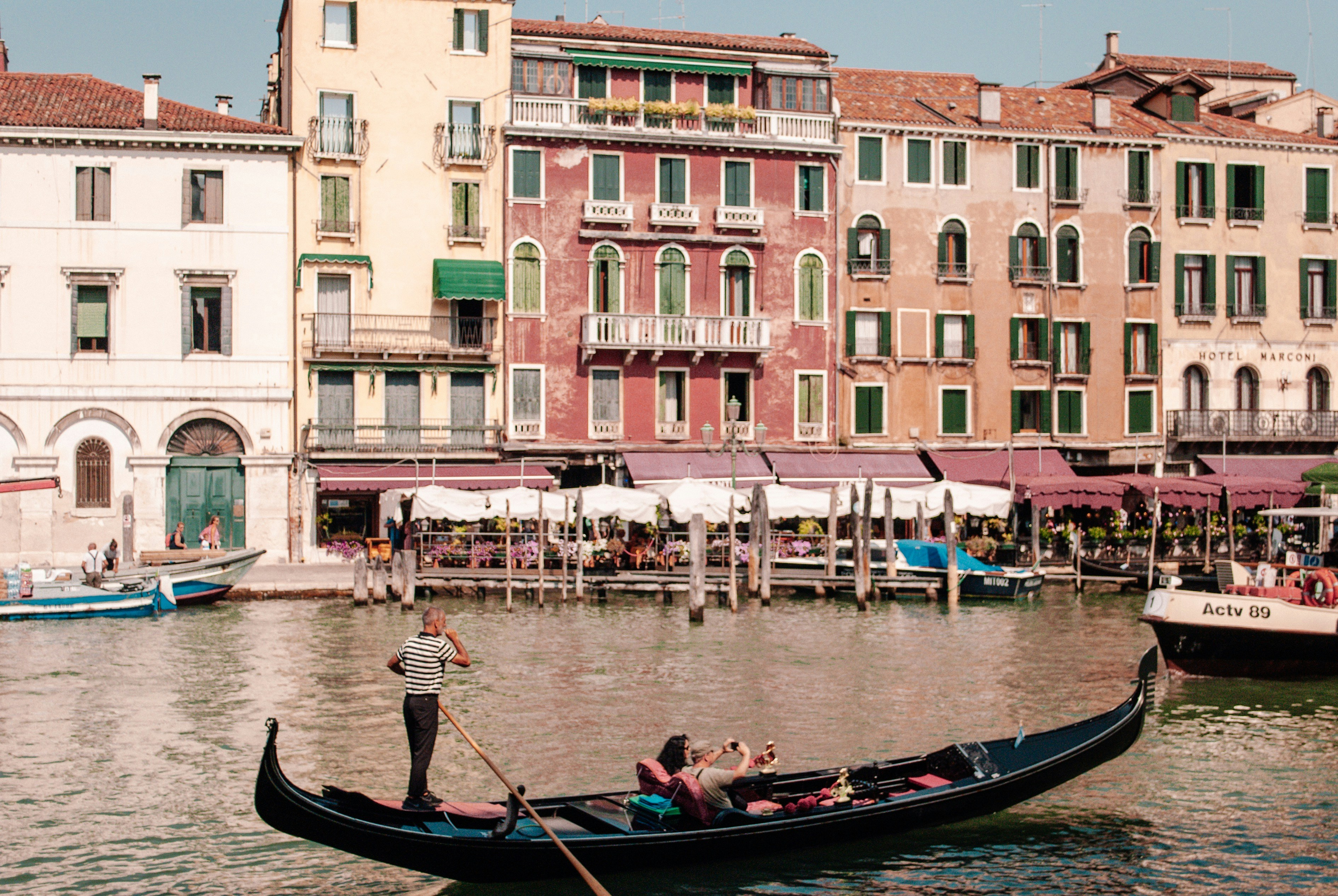 people riding boat near buildings