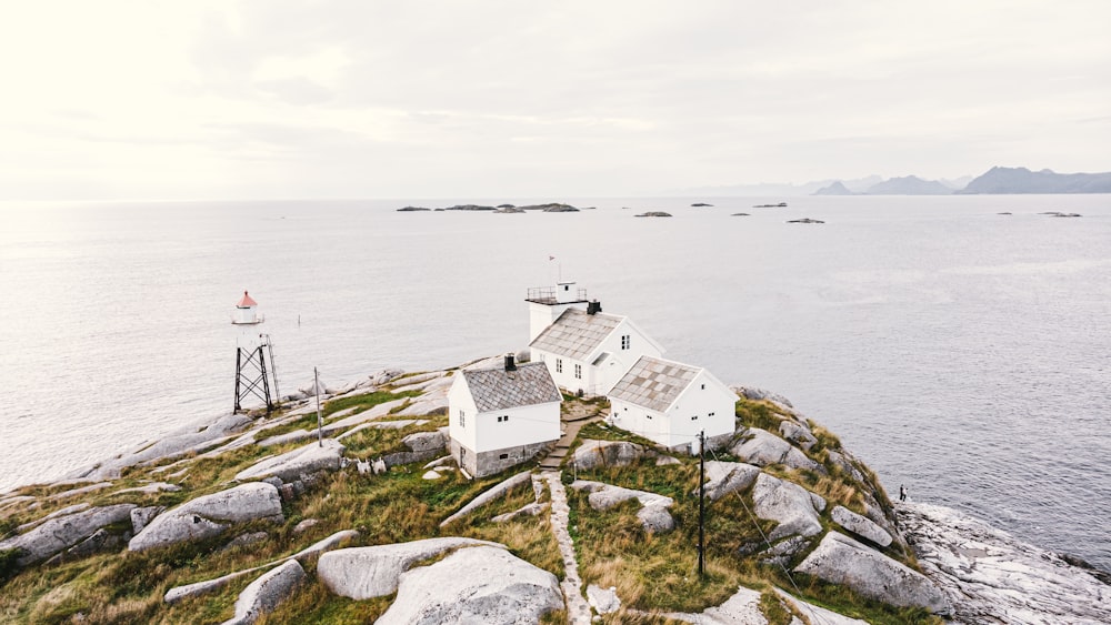 three white houses on island surrounded by sea