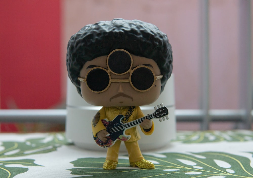 person playing guitar figurine