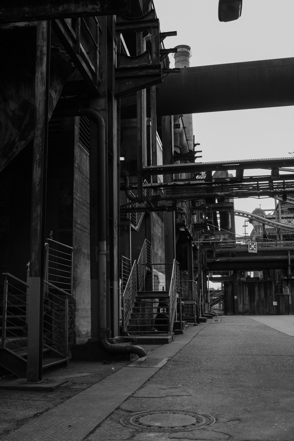 grayscale photography of buildings with ladders