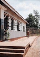 Armed security personnel patrolling a factory perimeter under clear skies.