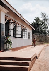 Security guard on foot patrol outside a commercial building during daylight.