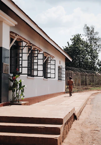 A security patrol walking confidently along a commercial property at sunrise.