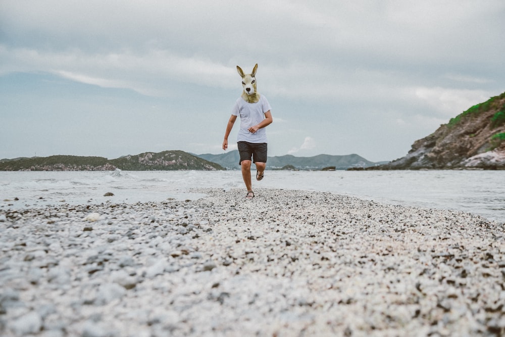 man running beside sea during daytime