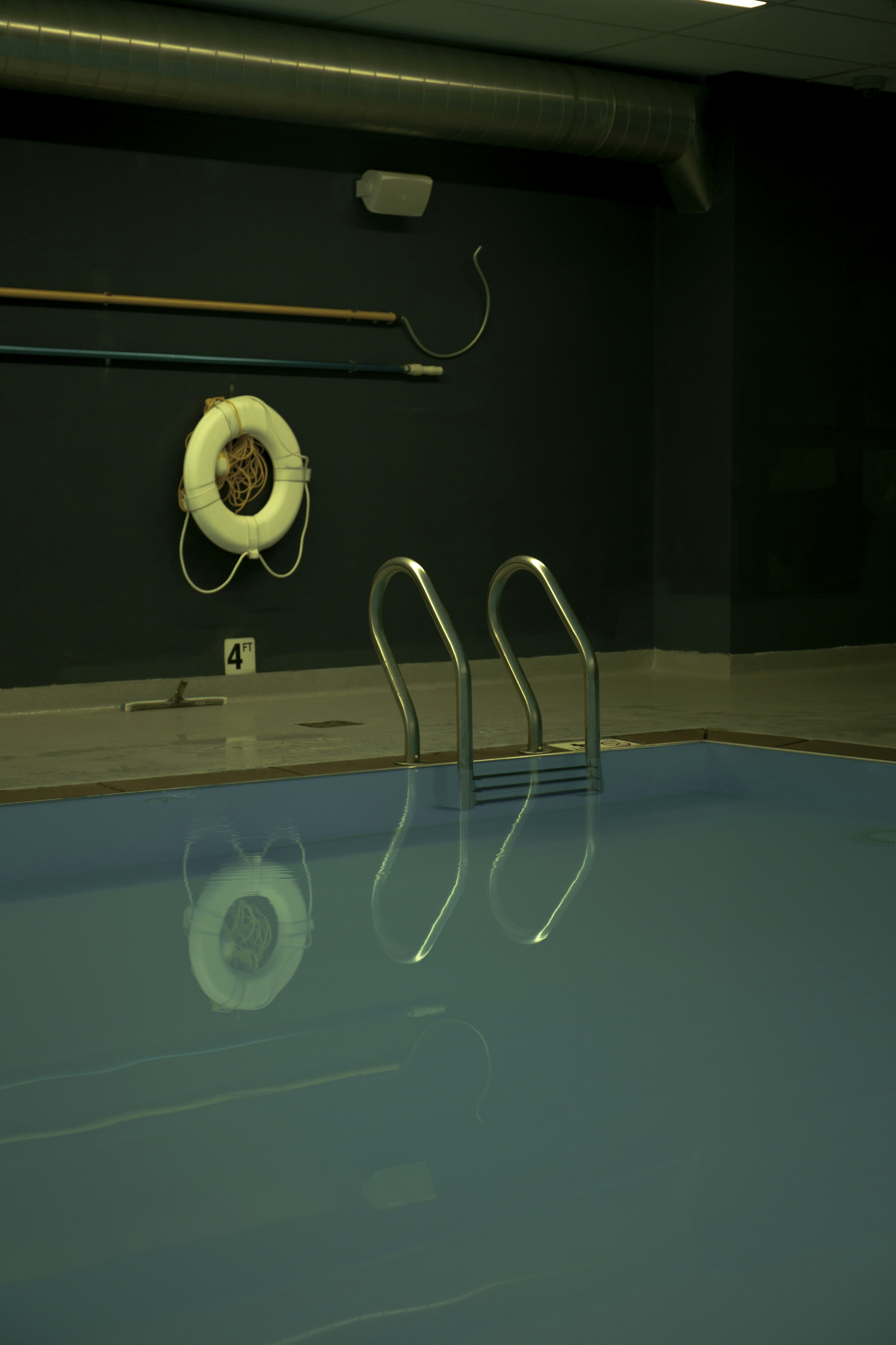 white lifebuoy near swimming pool