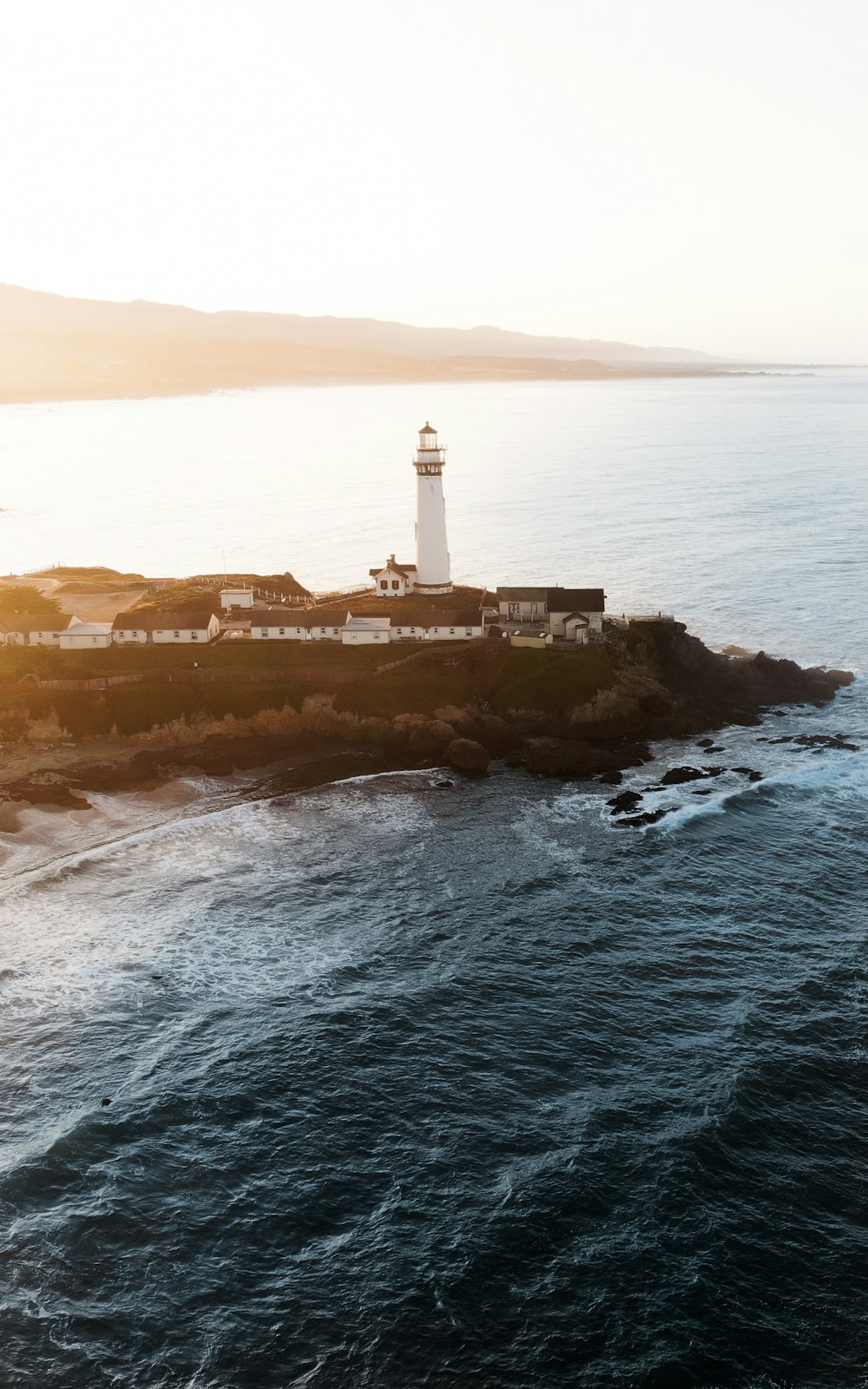 white lighthouse near body of water