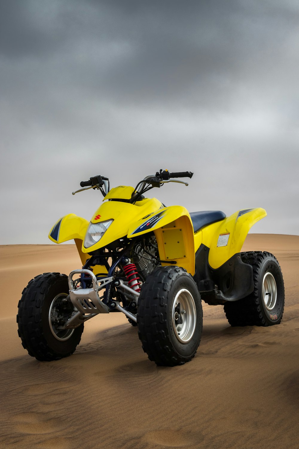 yellow all-terrain vehicle on desert