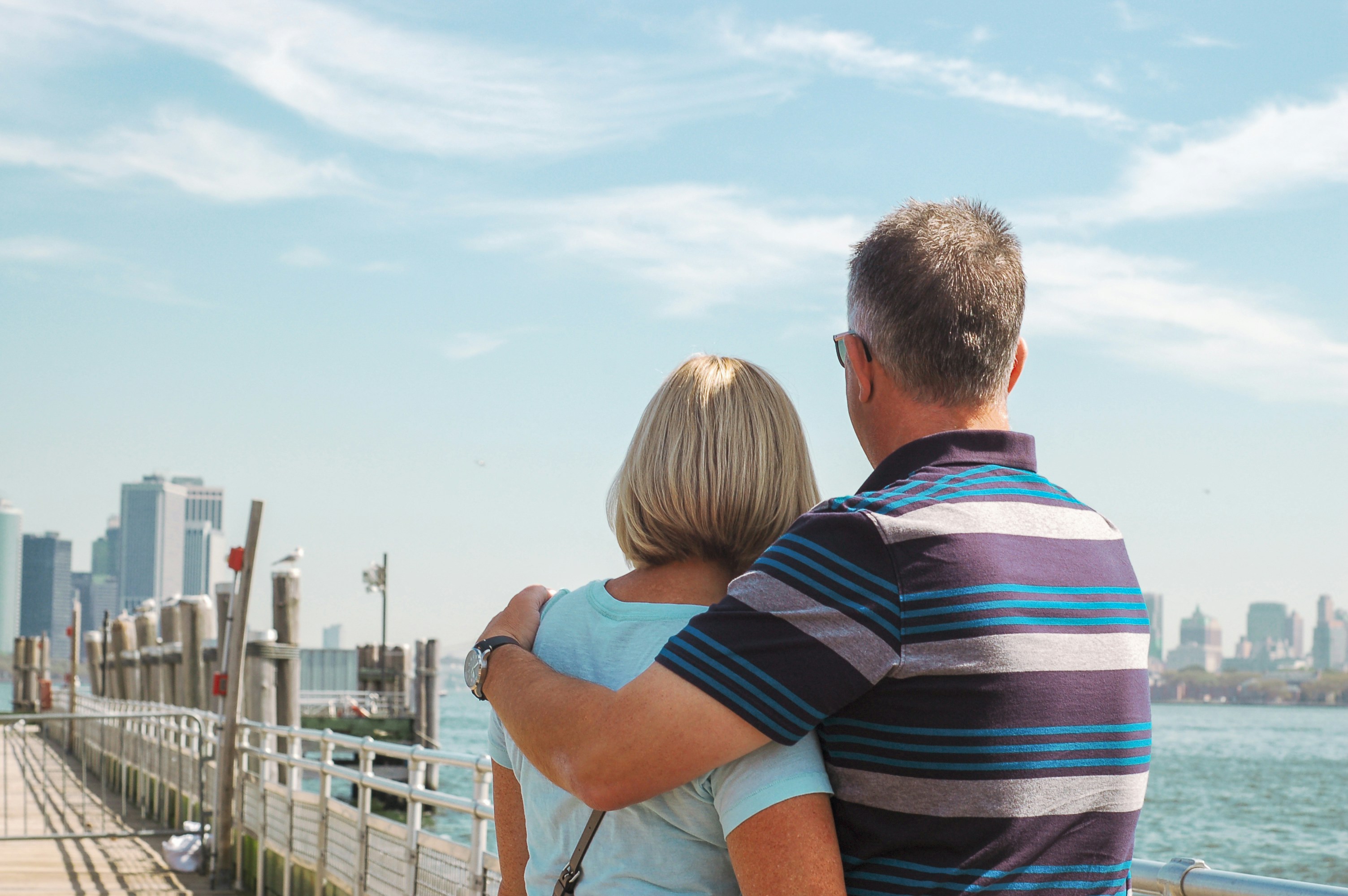 man's left arm on woman's shoulder