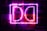 A collection of posters for various music concerts, illuminated by bright purple neon lights in the shape of the letters D and C. The posters feature artists like Ariana Grande, Imagine Dragons, Stevie Wonder, and others. The neon lights create a vibrant and electrifying atmosphere.