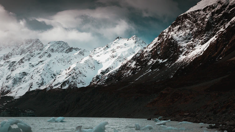 A serene southern Chilean landscape with cold winds sweeping over rugged mountains and calm waters.