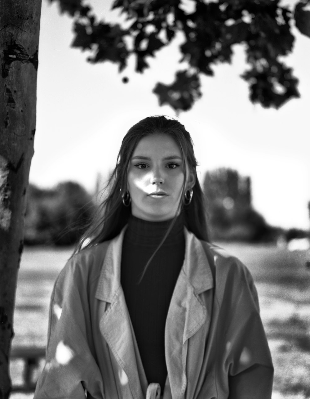 woman standing under tree