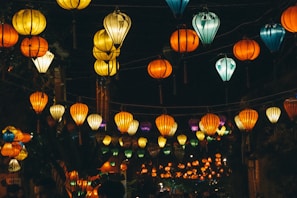 Colorful lanterns hanging during Ramadan nights, illuminating a festive street scene.