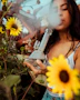 woman using bong blowing smoke