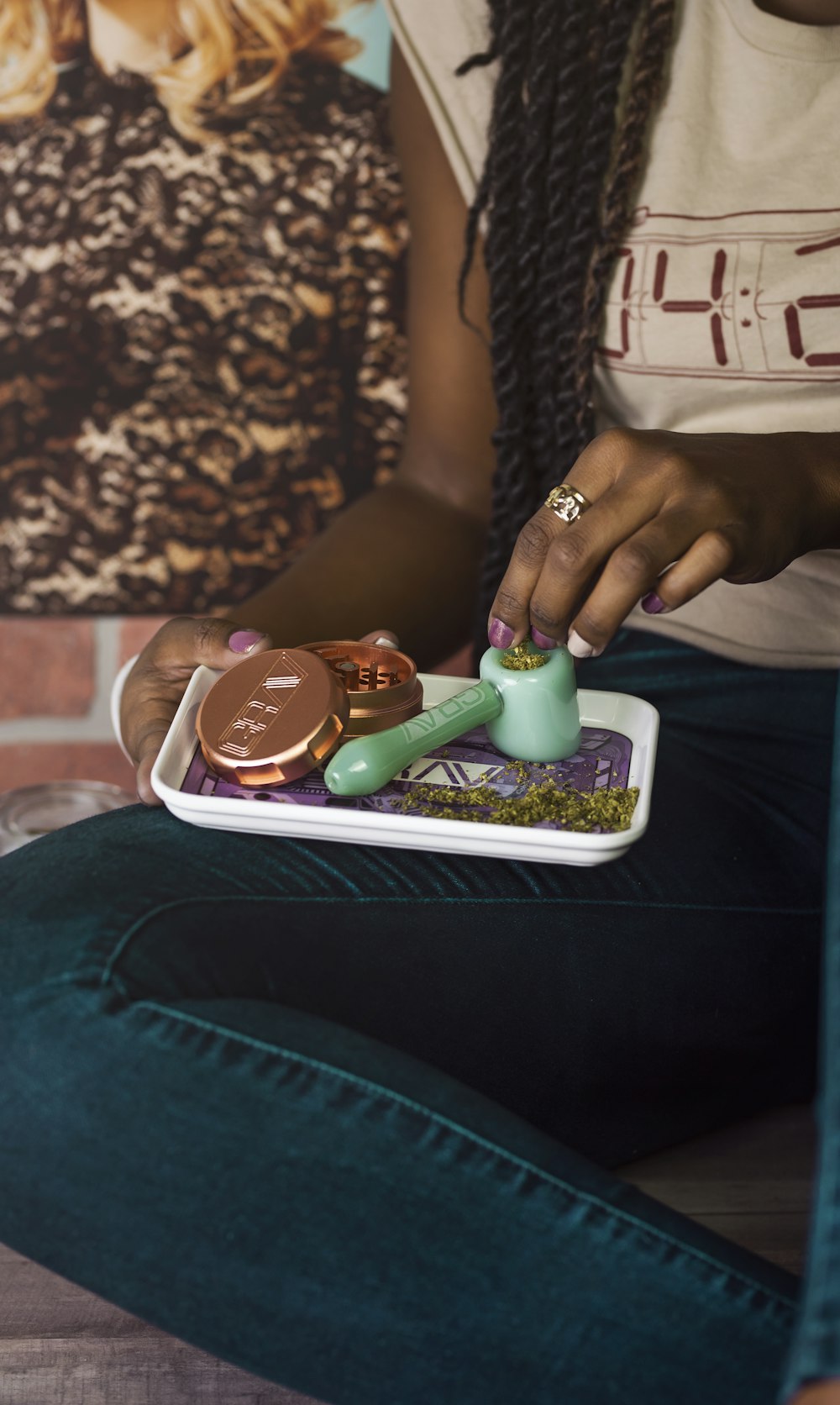 person preparing spoon pipe while sitting