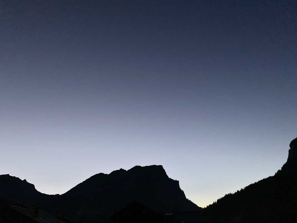 silhouette of mountain during night time