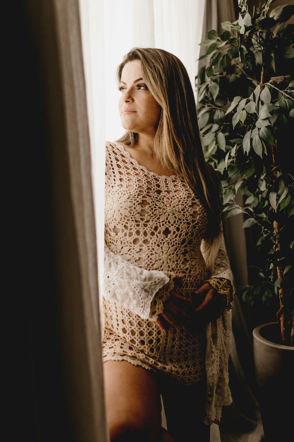 woman standing beside door