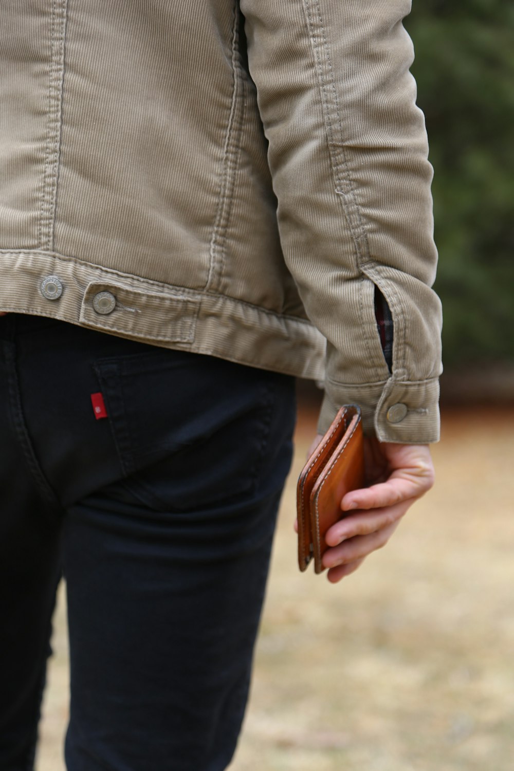 man walking on sand holding wallet