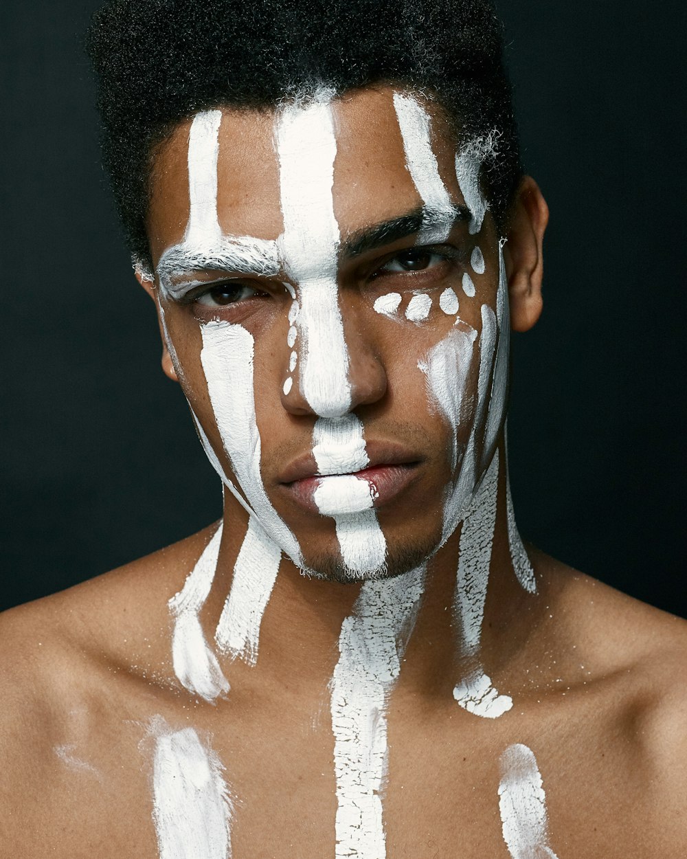 man with white paint on face