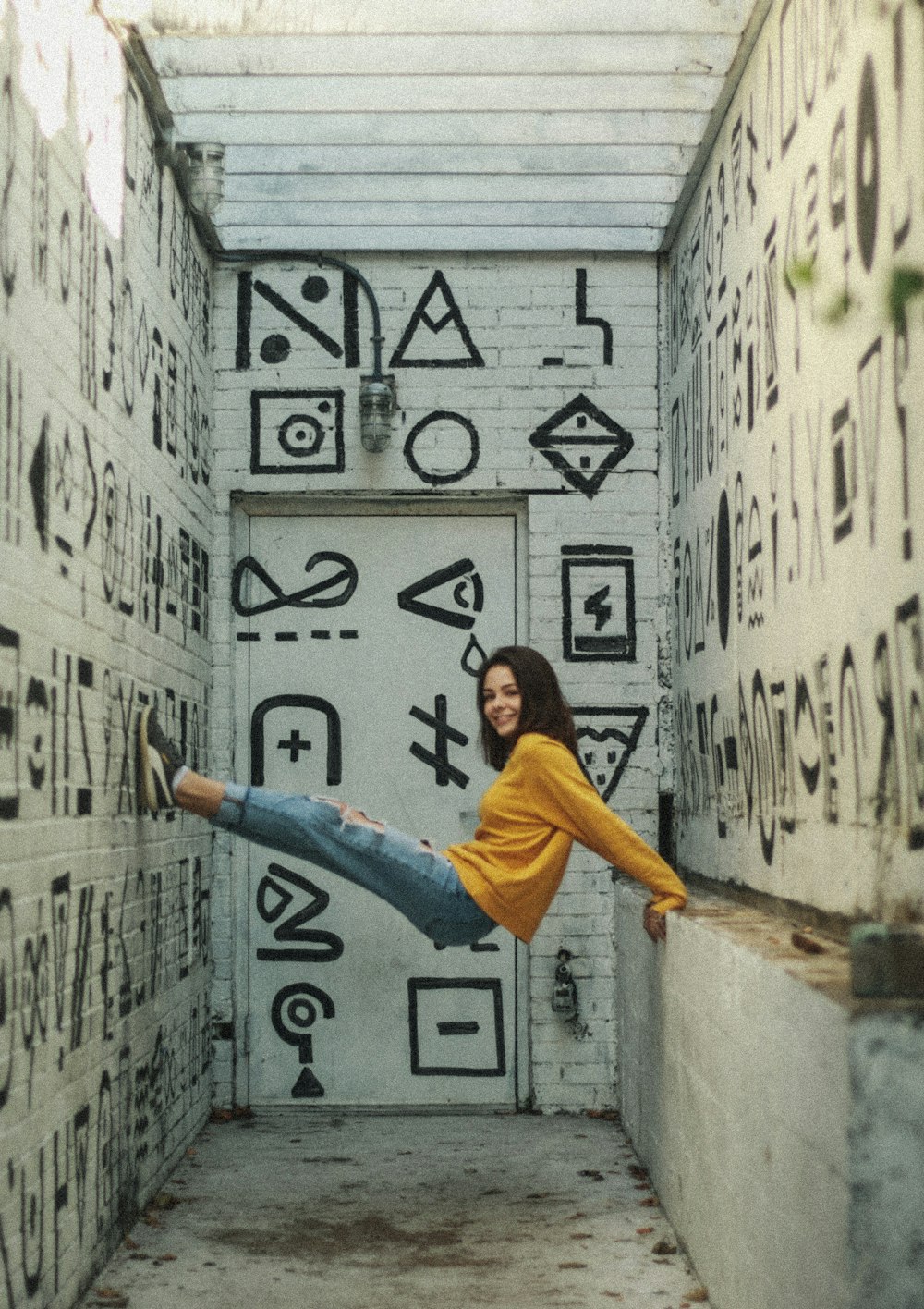 woman wearing brown sweater doing post on walls