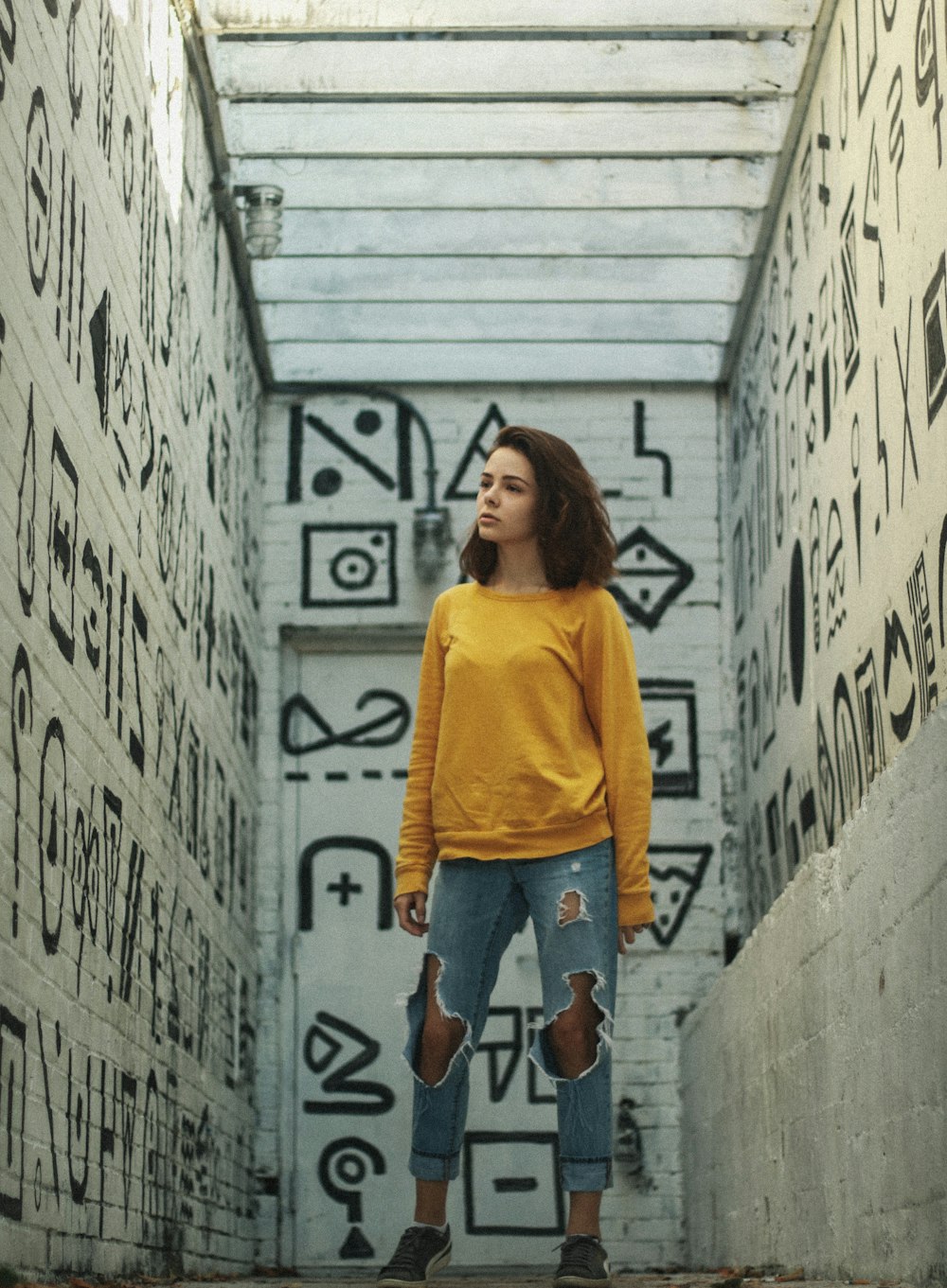woman standing in between walls