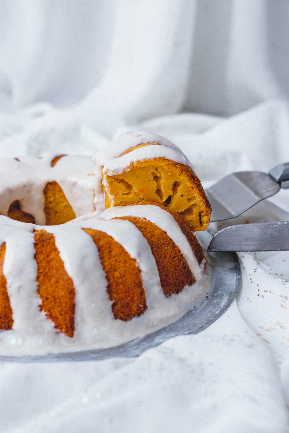 person slicing bundt cake