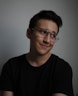 smiling man wearing black crew-neck t-shirt