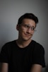 smiling man wearing black crew-neck t-shirt