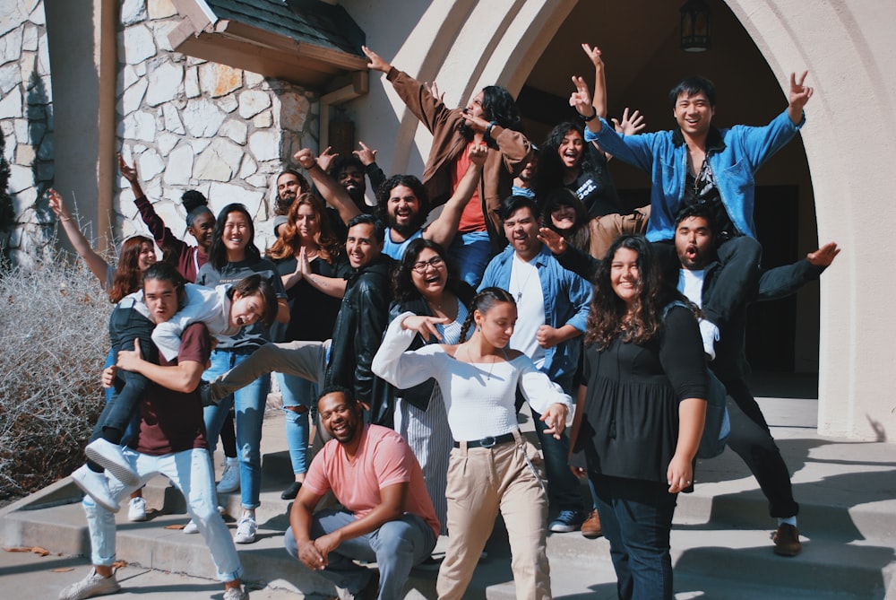 standing and sitting of people taking group photo