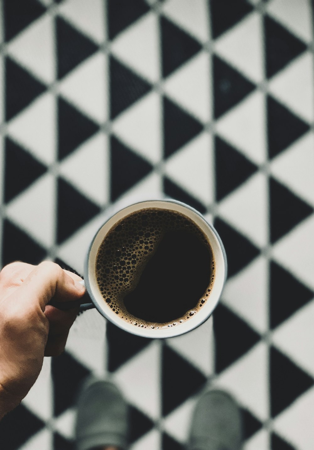 white and gray coffee mug with black coffee