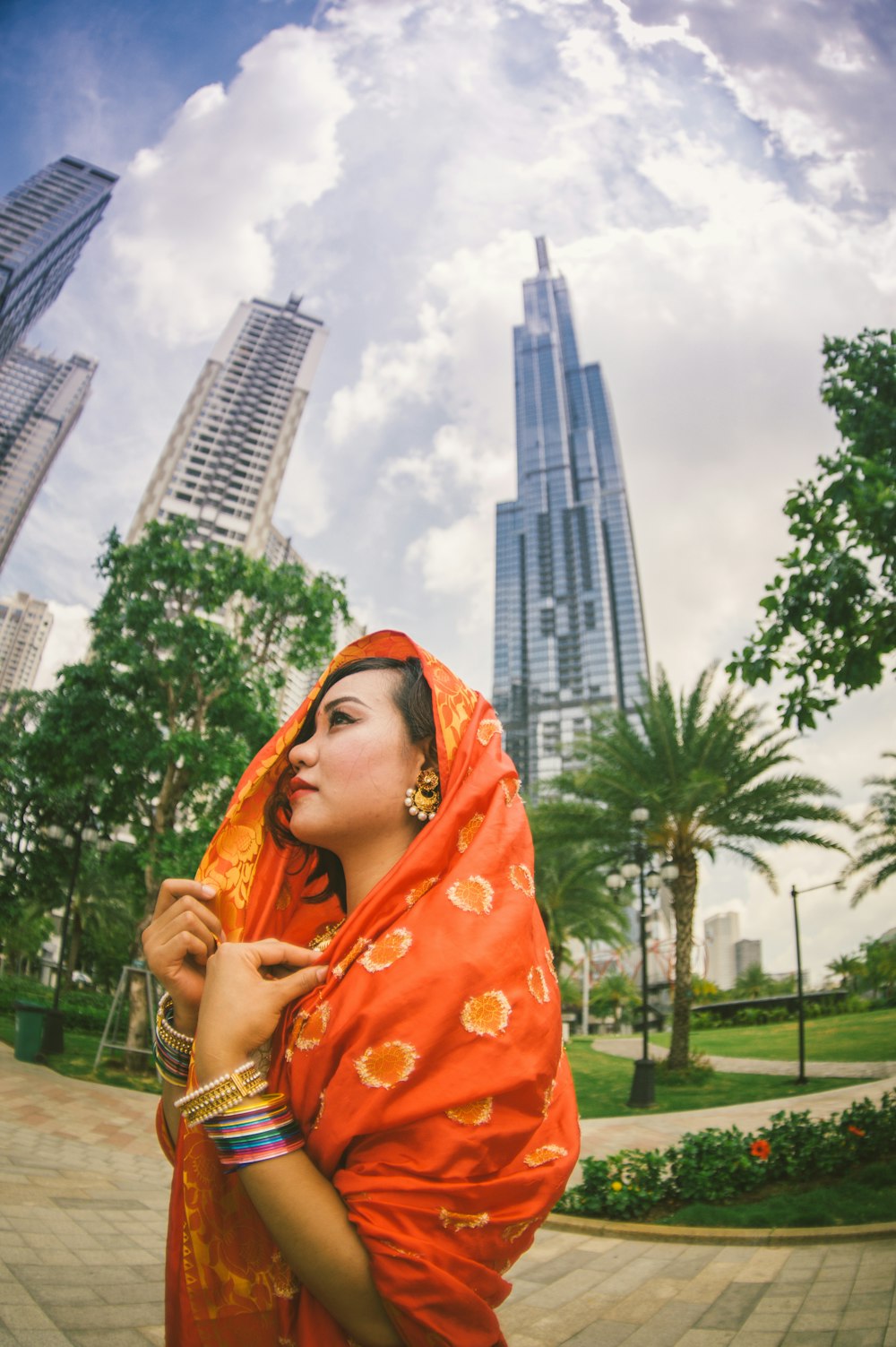 woman wears orange sari dress