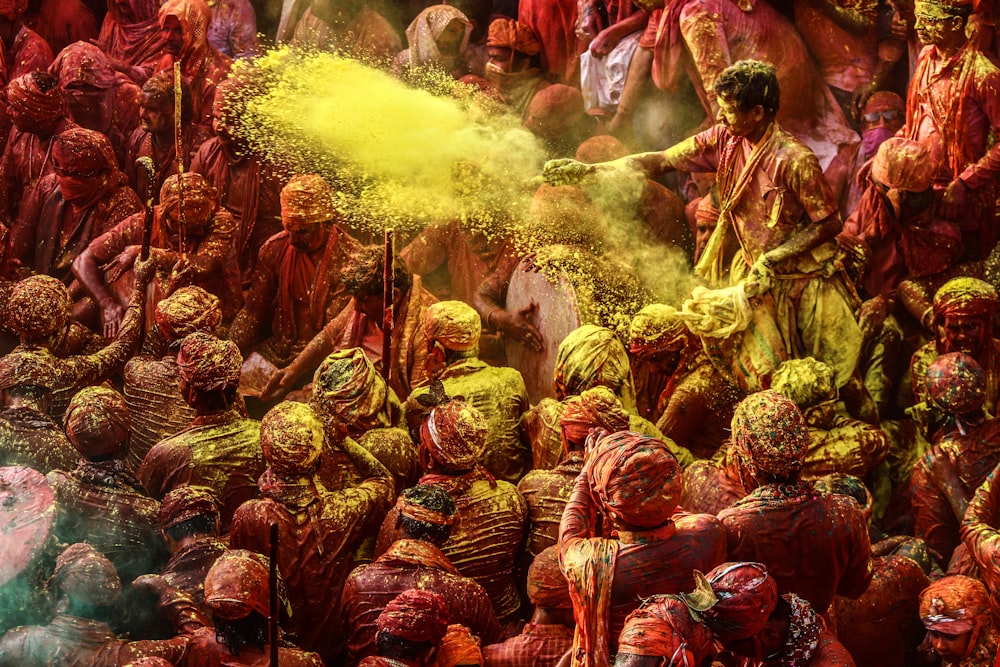 a group of people covered in colored powder