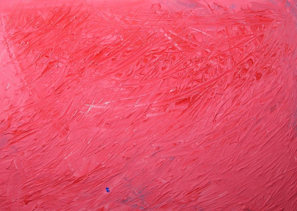 a red painting with a blue dot on it