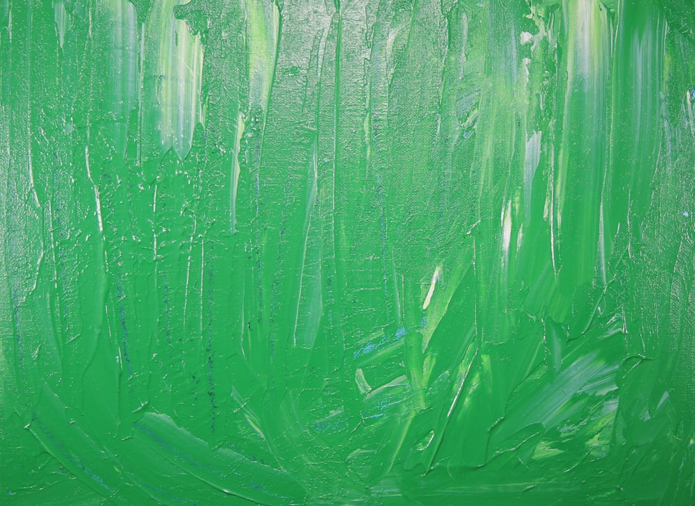an abstract painting of green paint on a green background