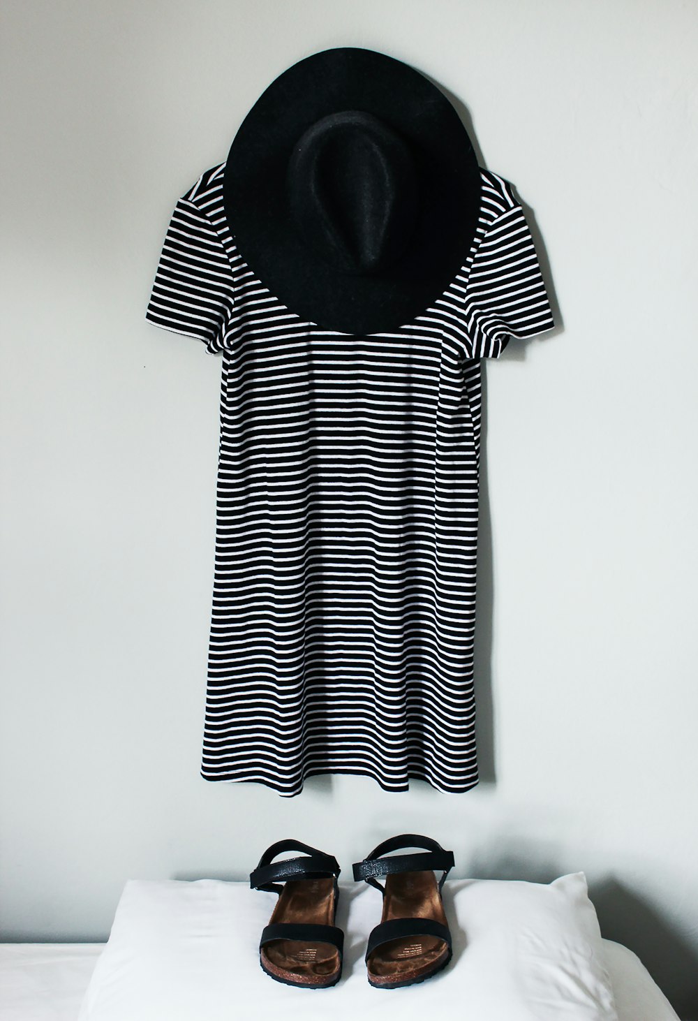 whit and black striped shirt hanging on white wall