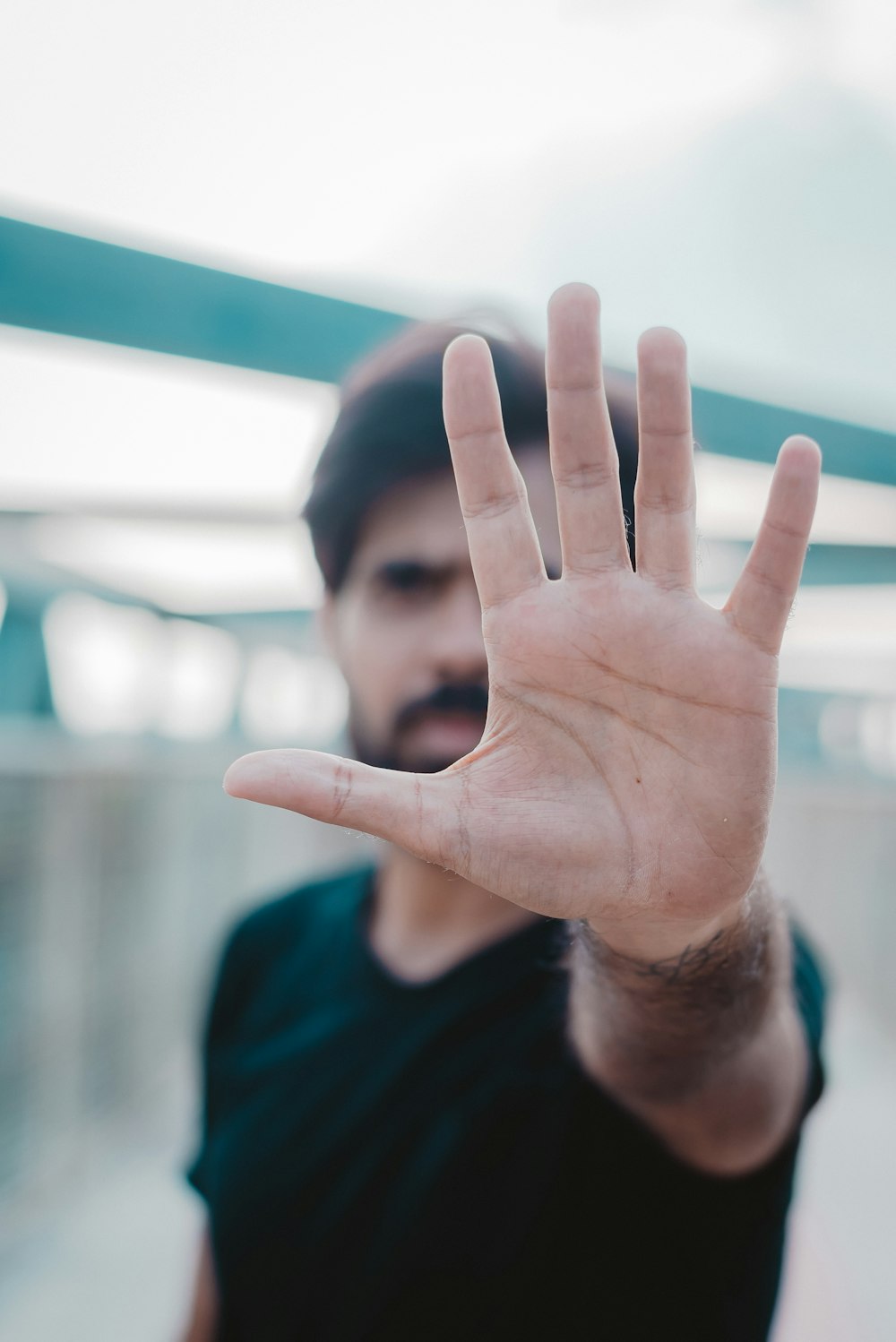 shallow focus photo of person showing left hand