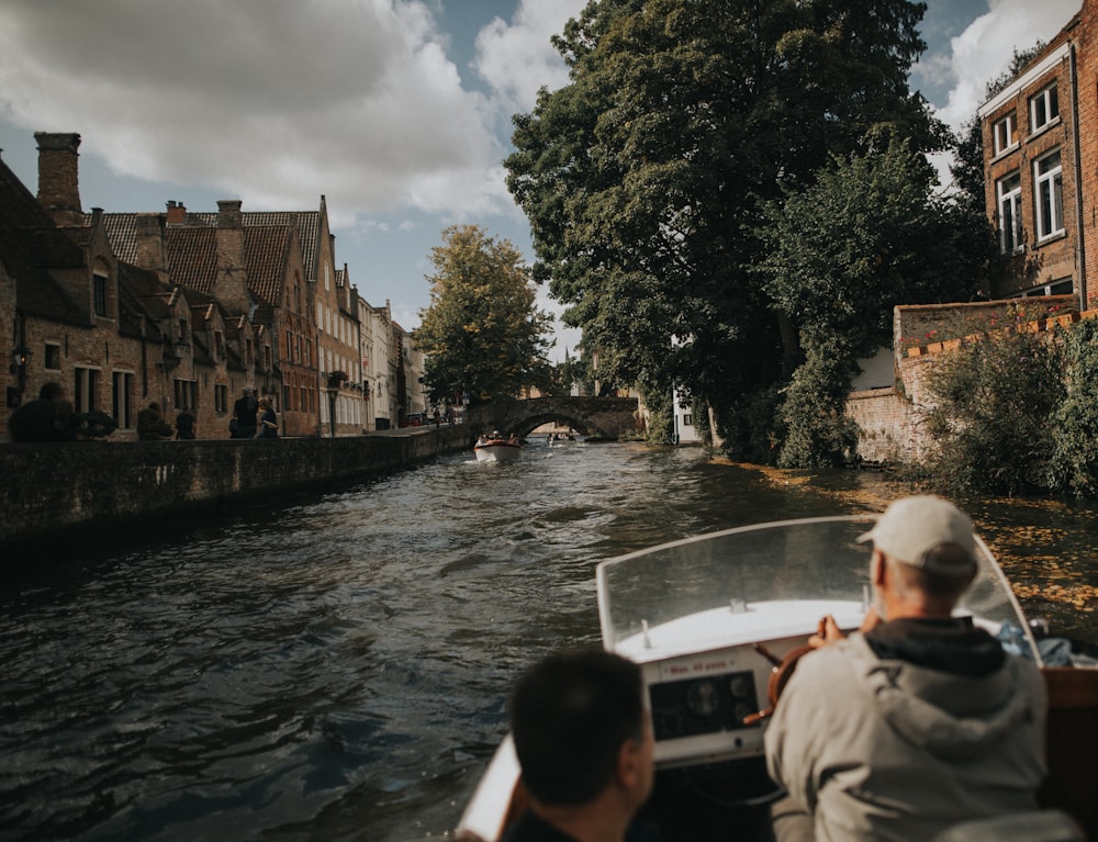 two men riding motorboat during daytime