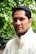 man standing near green leafed plants
