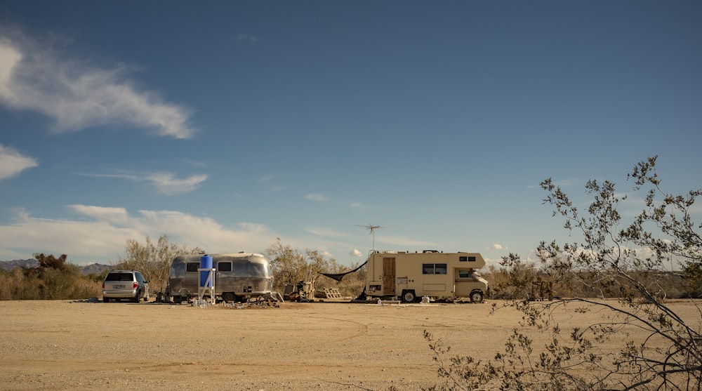 vehicles on brown field at daytime