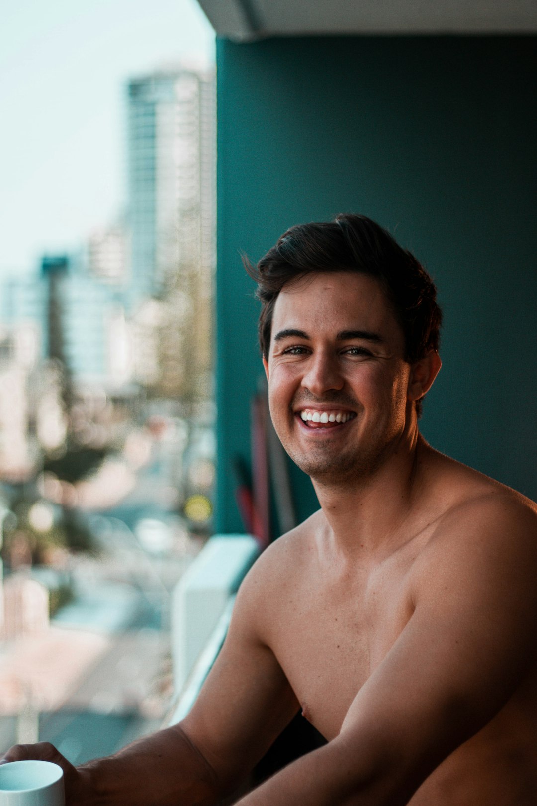 topless man smiling on focus photography