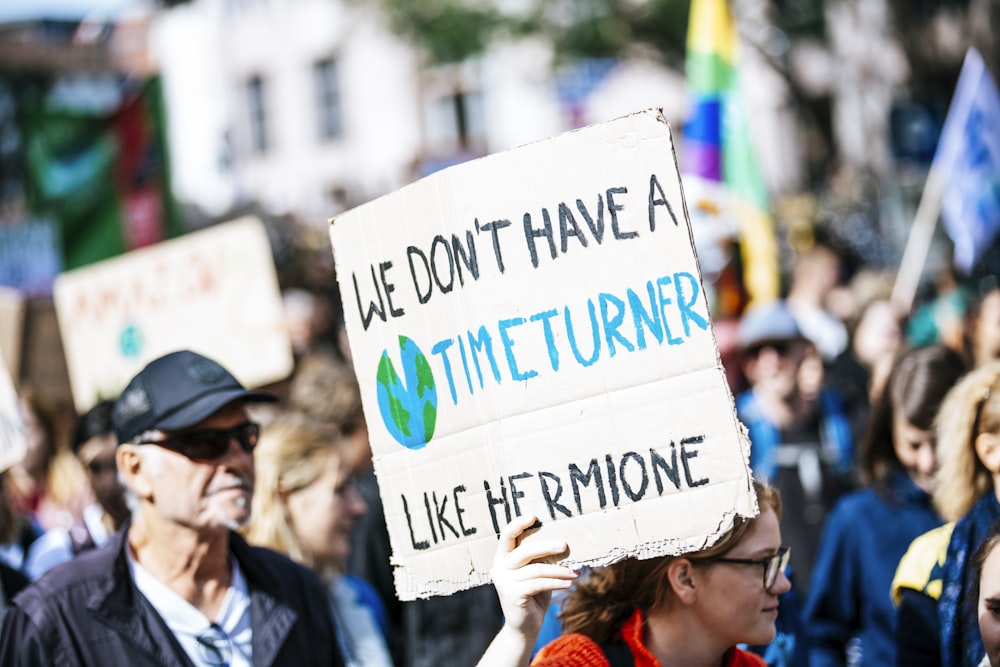 des personnes tenant des affiches pendant la journée ;