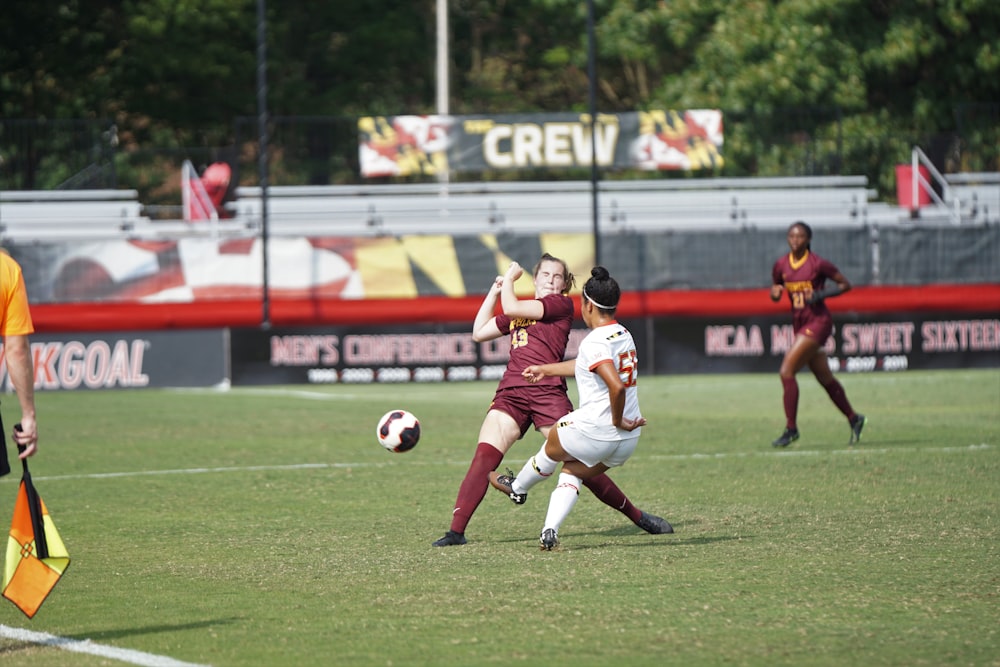 women playing soccer on field