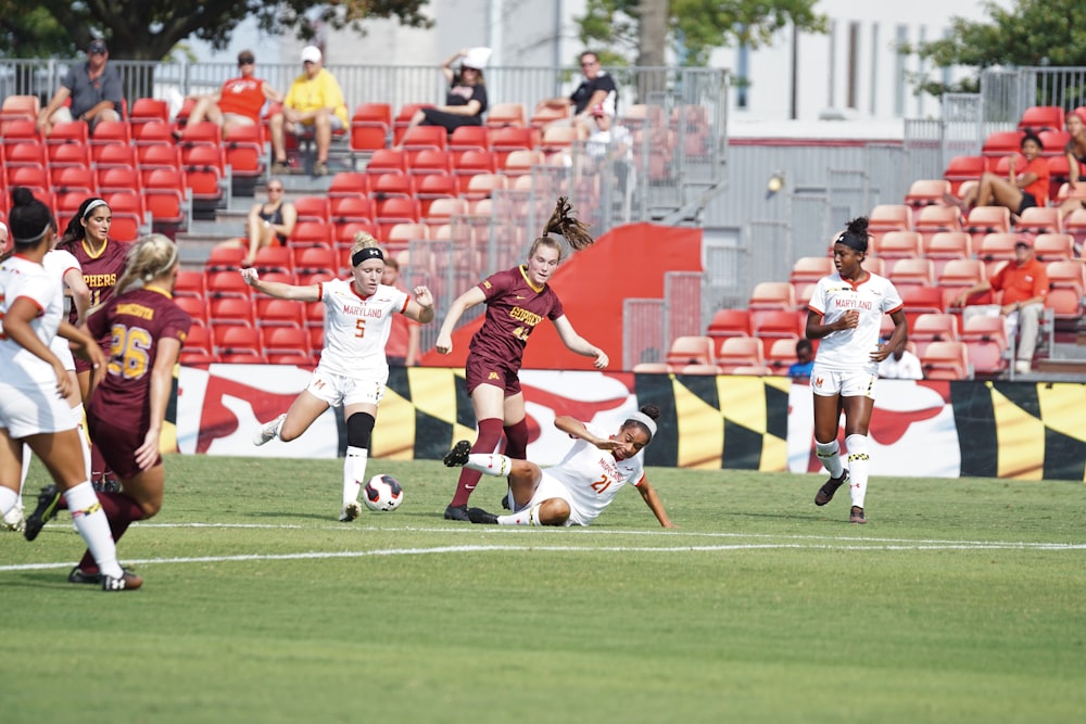 women playing soccer on field