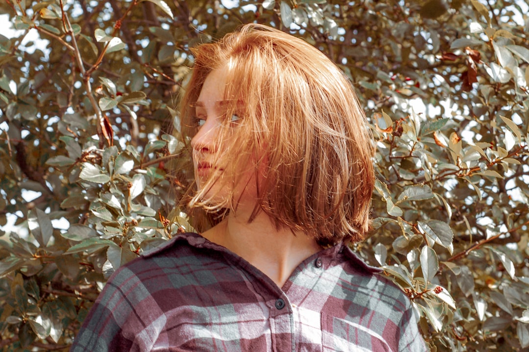 woman wearing red and gray plaid button-up shirt