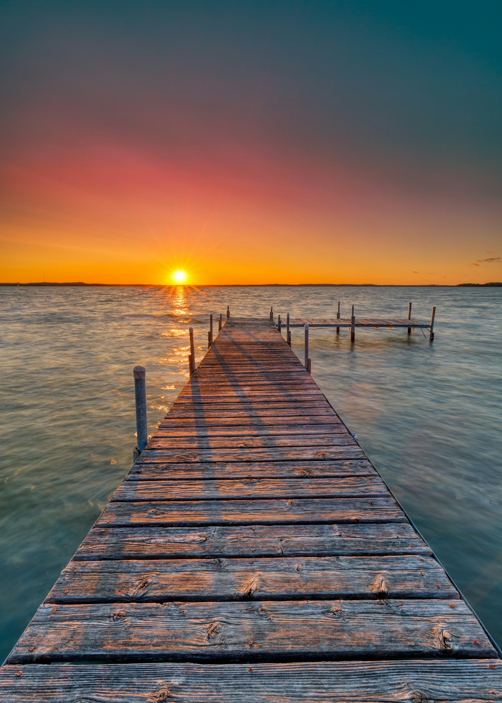 brown wooden pier under clear blue sky