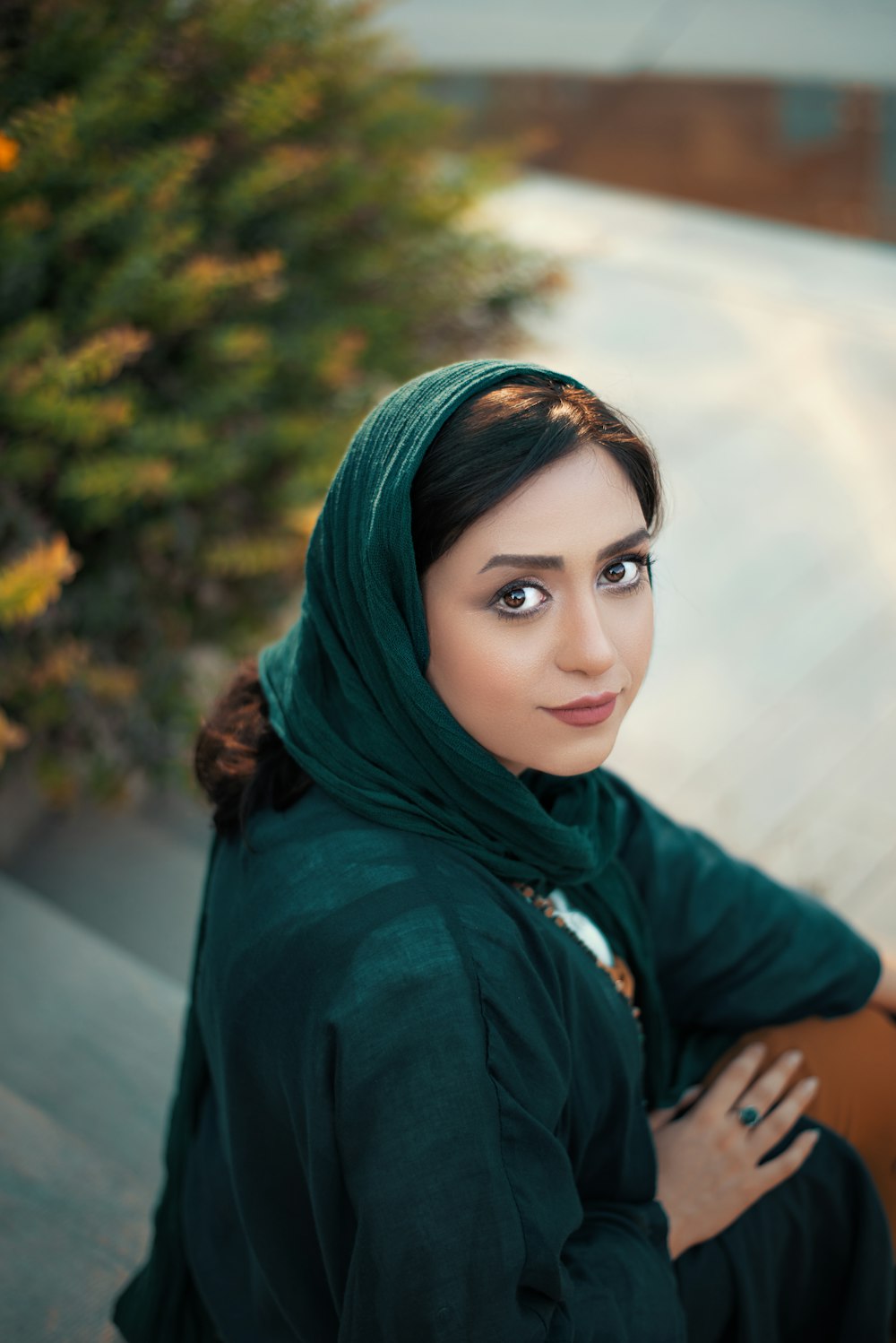 focus photography of woman in green headscarf