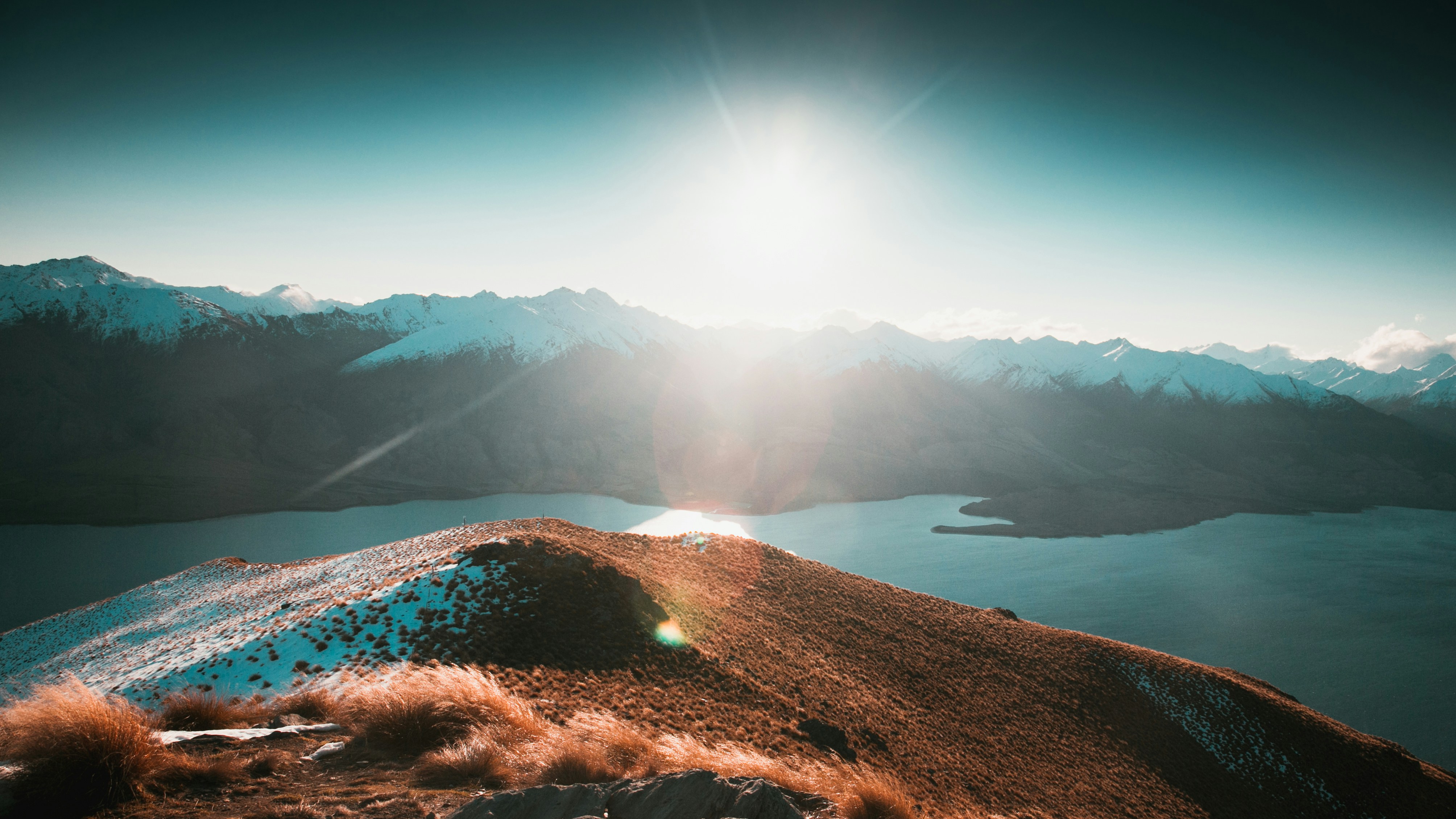 The sun shines brightly over a mountain range photo – Free Land Image ...