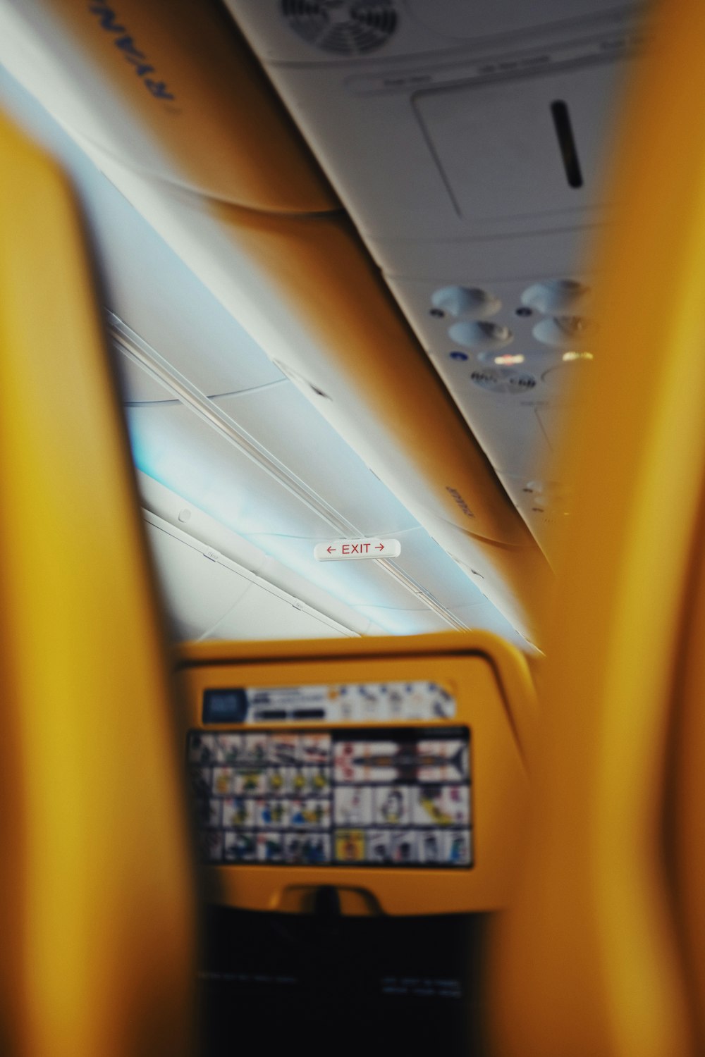 the interior of an airplane with yellow seats