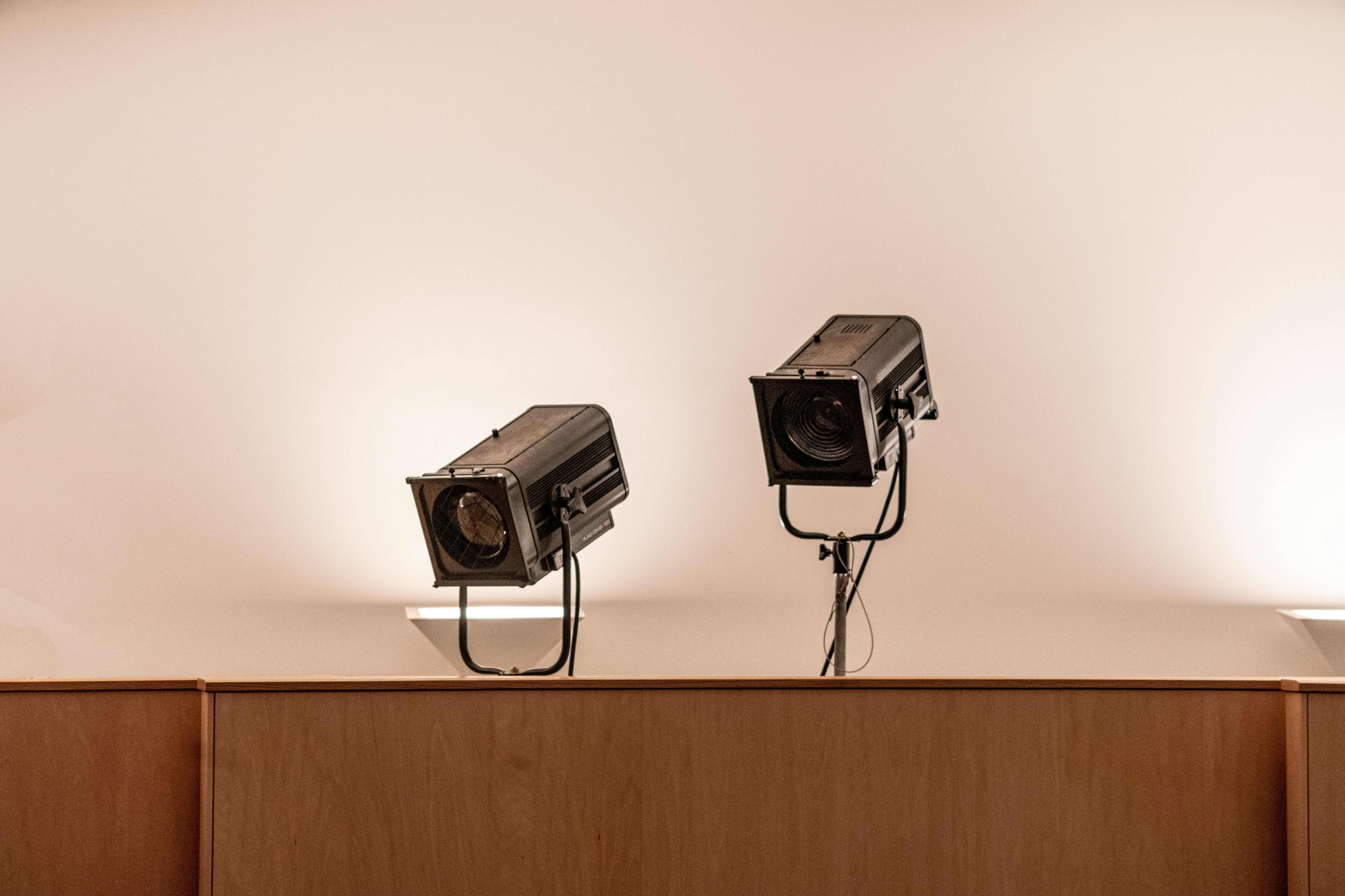 two black security cameras on white wall