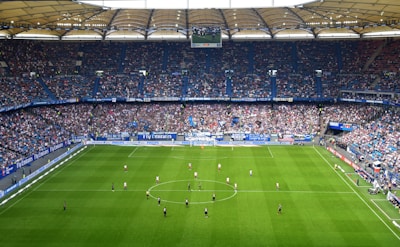 people inside soccer stadium during day
